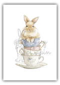 Sugar Bunnies- Bunny sitting a stack of cups with blue and pink cups